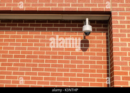 CCTV camera at a red brick wall, secutity Stock Photo