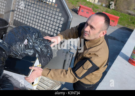 municipal dustman worker with cleaning tools in public streets Stock Photo