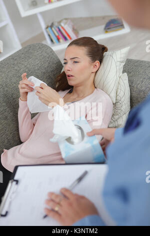 patient crying next to her therapist Stock Photo