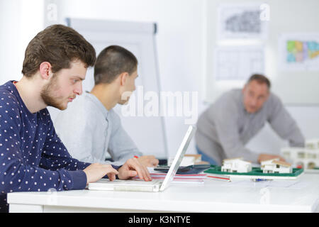 talented young architects watching professional master class Stock Photo