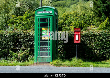 Green converted defibrillator and first aid telephone box, Berrow Green, Worcestershire, England, UK Stock Photo