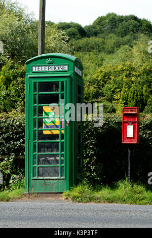 Green converted defibrillator and first aid telephone box, Berrow Green, Worcestershire, England, UK Stock Photo