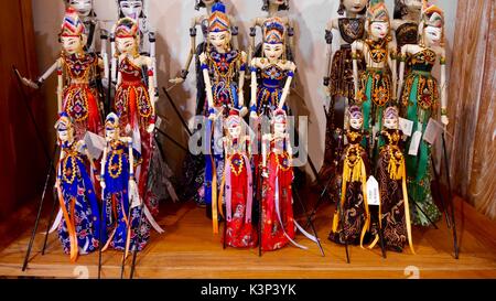 Row of delicate, hand-made, traditional wayang figures on sale in souvenir shop on the Indonesian island of Bali Stock Photo