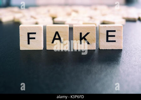 Fake words on a wood blocks, focus on the foreground with filter and analog effect Stock Photo