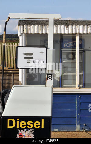 redundant petrol pumps disused at a derelict garage no longer selling petrol or diesel fuels of the future gasoline derv out of use rusty fuel petrol Stock Photo