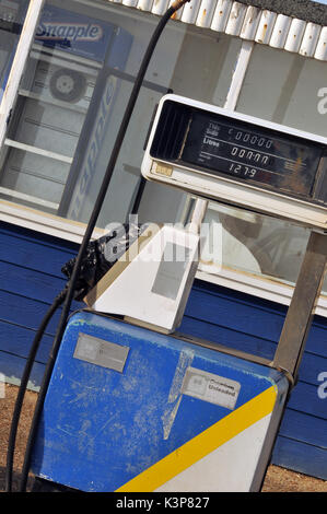 redundant petrol pumps disused at a derelict garage no longer selling petrol or diesel fuels of the future gasoline derv out of use rusty fuel petrol Stock Photo