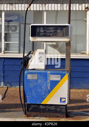 redundant petrol pumps disused at a derelict garage no longer selling petrol or diesel fuels of the future gasoline derv out of use rusty fuel petrol Stock Photo