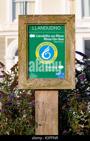 Wales Coast Path sign showing directions to Conwy and LLandrillo-yn-Rhos or Rhos-on-Sea at Llandudno in North Wales, UK Stock Photo