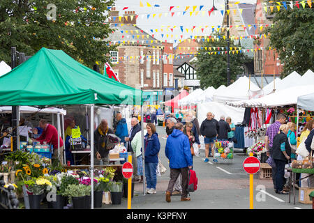 People visiting the popular market day in the high street at the North Wales market town of Mold, Flintshire, Wales, UK Stock Photo