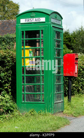 Green converted defibrillator and first aid telephone box, Berrow Green, Worcestershire, England, UK Stock Photo