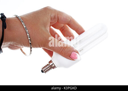 Woman hand holding Fluorescent, energy saving light bulb on isolated white cutout background. Studio photo with studio lighting easy to use for every Stock Photo