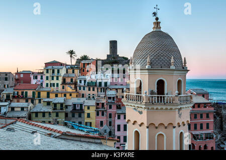 A detail of the church of Vernazza, one of the prettiest village of the Cinque Terre. In the background, pastel-colored houses overlooking the little natural harbor make Vernazza simply enchanting - Cinque Terre National ParK, Liguria, Italy Europe Stock Photo