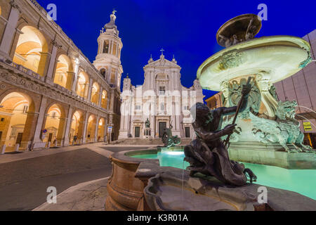 Night view of the Basilica of the Holy House and fountain decorated with statues Loreto Province of Ancona Marche Italy Europe Stock Photo