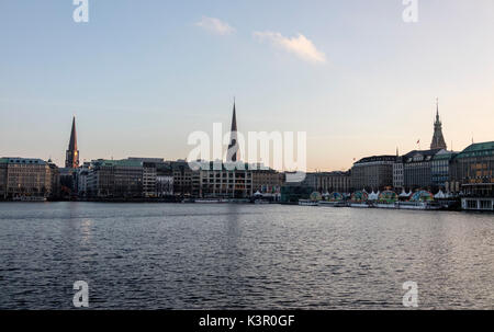 The artificial Inner Alster Lake frames the old buildings and palace of the city center Hamburg Germany Euope