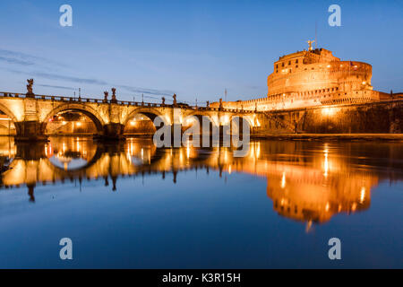 Dusk on the ancient palace of Castel Sant'Angelo with statues of angels on the bridge on Tiber RIver Rome Lazio Italy Europe Stock Photo
