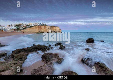 Sunset on the village of Carvoeiro surrounded by sandy beach and clear sea Lagoa Municipality Algarve Portugal Europe Stock Photo