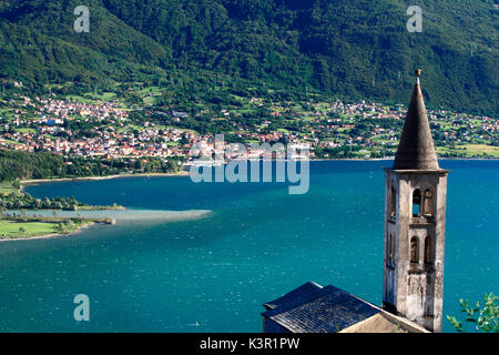 The church tower of Montemezzo overlooking Lake Como. In the background Colico the last town on the eastern shore of Lario. Lombardy. Italy. Europe Stock Photo