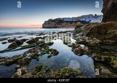 Sunset on the village perched on the promontory overlooking the beach of Carvoeiro Algarve Lagoa Faro District Portugal Europe Stock Photo