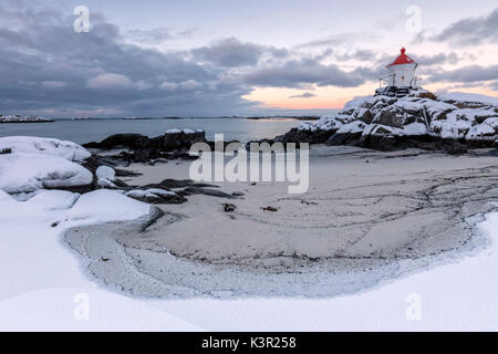 Colorful arctic sunset on the lighthouse surrounded by snow and icy sand Eggum Vestvagoy Island Lofoten Islands Norway Europe Stock Photo