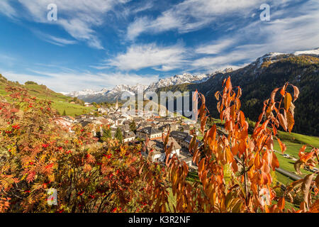 Autumn colors frame the village of Ardez surrounded by woods and snowy peaks Engadine Canton of Graubünden Switzerland Europe Stock Photo