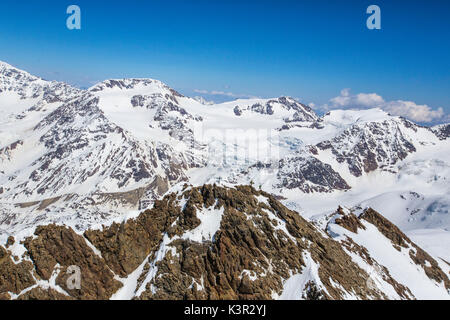 Aerial view of alpine skiers on peaks Dosegu and Mount Vioz Stelvio National Park Valtellina Valfurva Lombardy Italy Europe Stock Photo