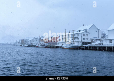 Heavy snowfall over the typical fishing village of Henningsvaer Lofoten Islands Northern Norway Europe Stock Photo