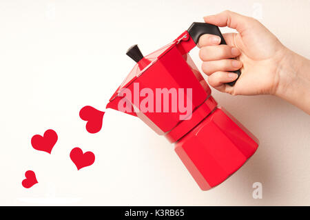 hand pouring hearts from a coffee maker moka machine, love for coffee concept Stock Photo