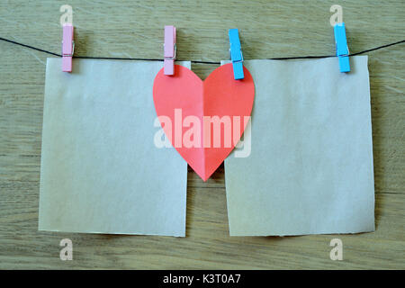 clothespin hanging with blank paper on wooden background Stock Photo