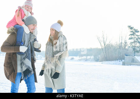 Family with child on winter holidays walking in the nature Stock Photo