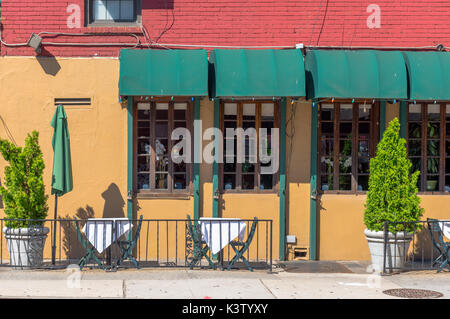 New York, NY USA August 3, 2016 Colorful outdoor dining area of a restaurant on West 22nd Street where the inside is also visible through the windows. Stock Photo