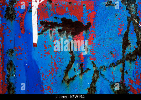 Abstract close up of red and blue paint and rust on metal Stock Photo