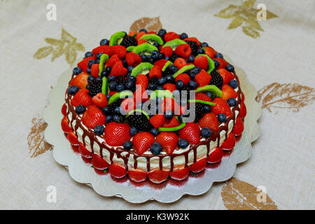 Delicious cake with fruit and berries decoration on wooden table fruit cake Stock Photo