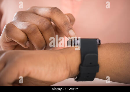 Close-up Photo Of African Person Using Smartwatch Stock Photo