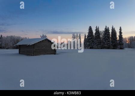 dawn winter morning in the village with snow covered trees in garden. Colorful outdoor scene, Happy New Year celebration concept. Artistic style post  Stock Photo