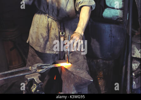 Blacksmith working on metal on anvil at forge high speed detail shot Stock Photo
