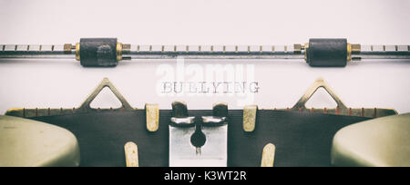 Close-up of BULLYING word on a typewriter sheet Stock Photo