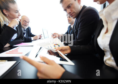 Mixed group of people in business meeting working with documents and computers Stock Photo