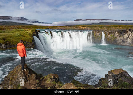 Man standing in front of Godafoss waterfall, Iceland Stock Photo