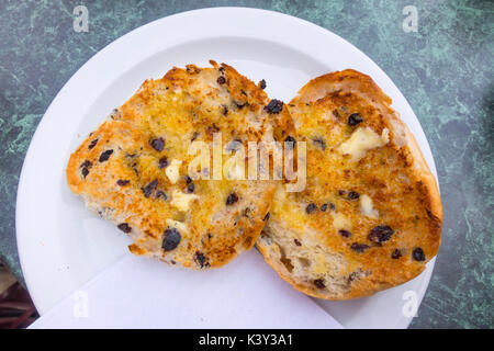 Buttered toasted teacakes a  breakfast or afternoon tea snack in England UK Stock Photo