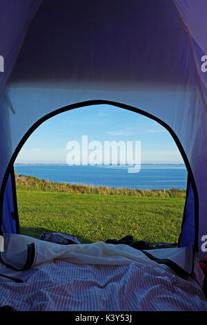 Sea view looking out of from tent in summer from Porthclais campsite camping near St Non's and St David's Pembrokeshire Wales UK Britain  KATHY DEWITT Stock Photo
