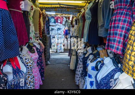 Clothes on display on half mannequins in a market stall on Camden Town high Street in London. Stock Photo