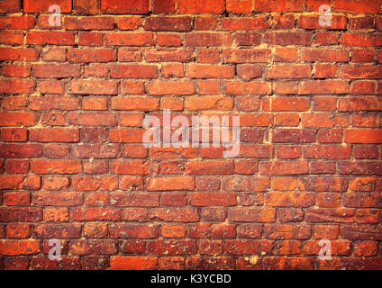 Background of old grunge brick wall texture with delicate vignetting. Stock Photo