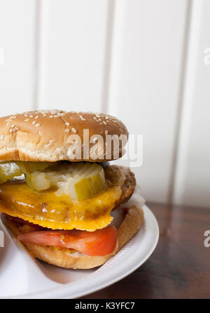 Veggie cheeseburger with pickles, tomatoes and ketchup Stock Photo