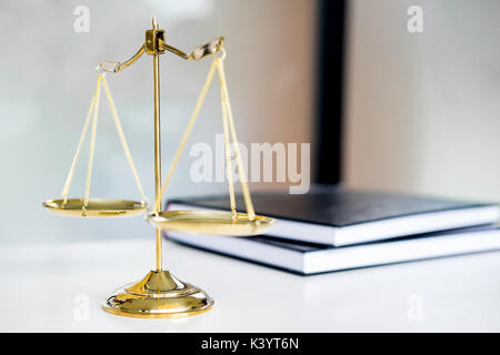 Law scales or golden weight and legals books on table. Symbol of justice. Stock Photo