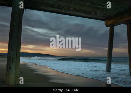 A sunrise from beneath the Pier in Hermosa Beach, California. Stock Photo