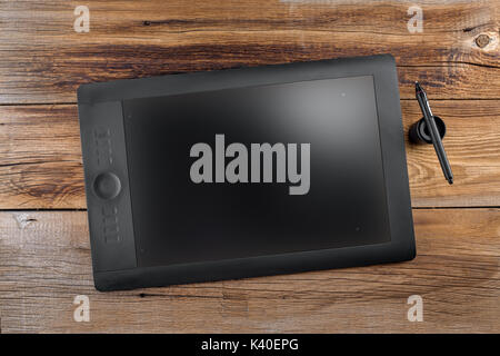 Graphics tablet Pen&Touch on a wooden background Stock Photo