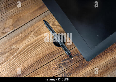 Graphics tablet Pen&Touch on a wooden background Stock Photo
