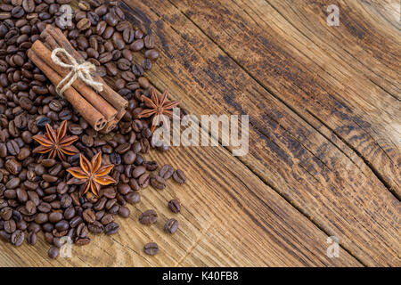 Coffee grains, anise and canella on old planks Stock Photo