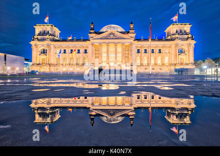 The Reichstag building at night in Berlin. (The dedication Dem deutschen Volke, meaning To the German people, can be seen on the frieze) Stock Photo