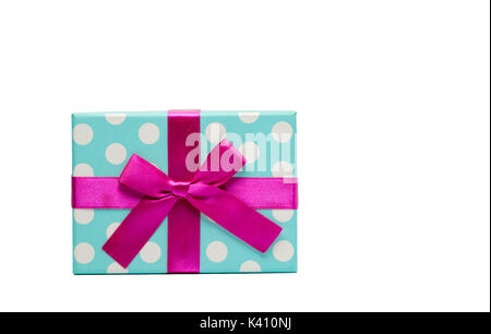 Polka dotted gift box with pink ribbon bow isolated on white background with copy space, just add your own text. Use for Christmas and new year festiv Stock Photo